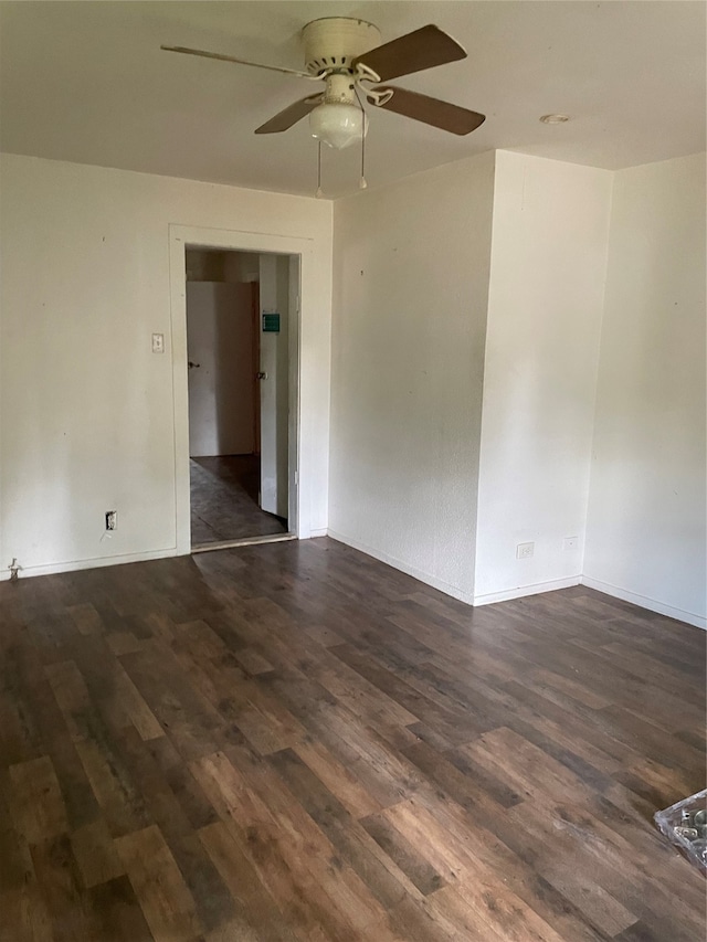 spare room with dark hardwood / wood-style floors and ceiling fan