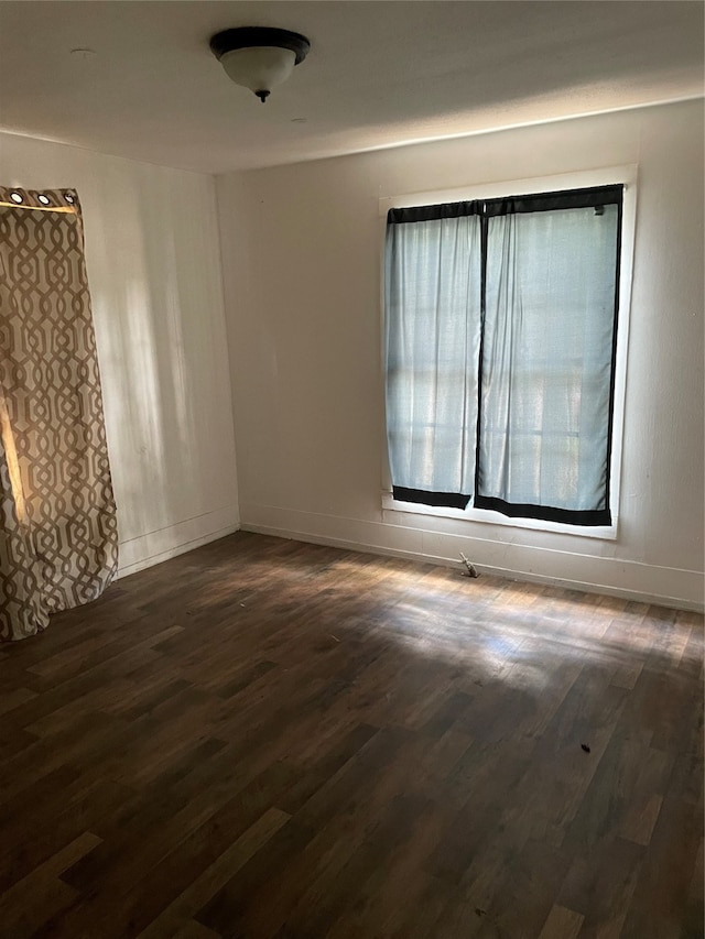 spare room with dark hardwood / wood-style flooring