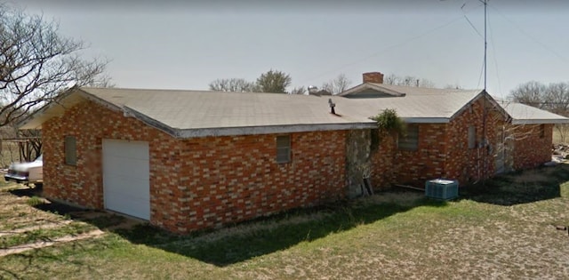 view of side of home with a yard and a garage