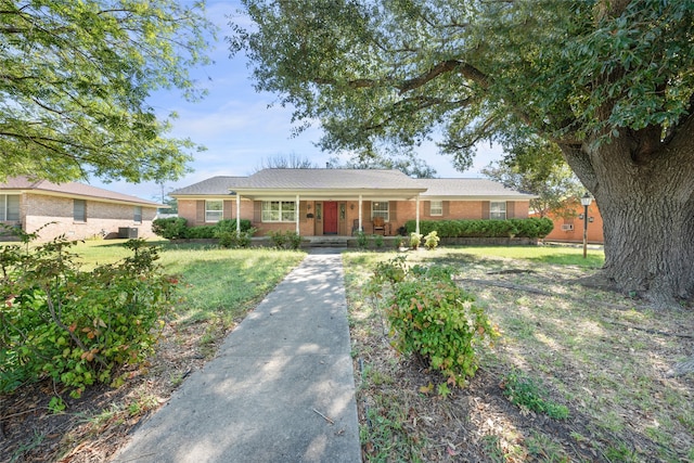 single story home featuring covered porch and a front yard