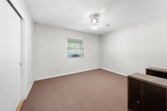 interior space with carpet and ceiling fan