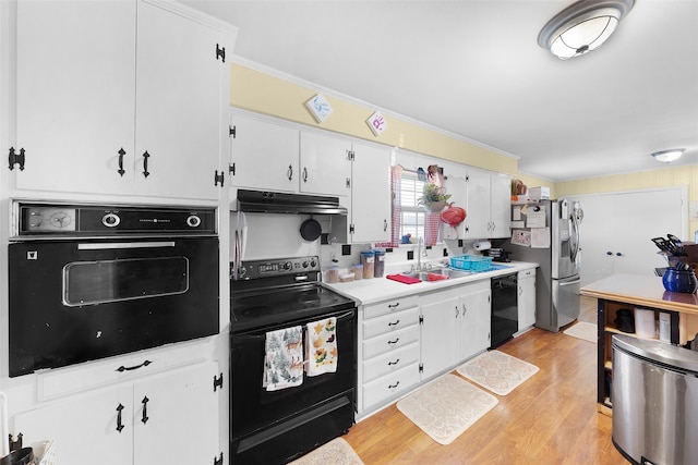 kitchen featuring light hardwood / wood-style floors, white cabinets, black appliances, crown molding, and sink