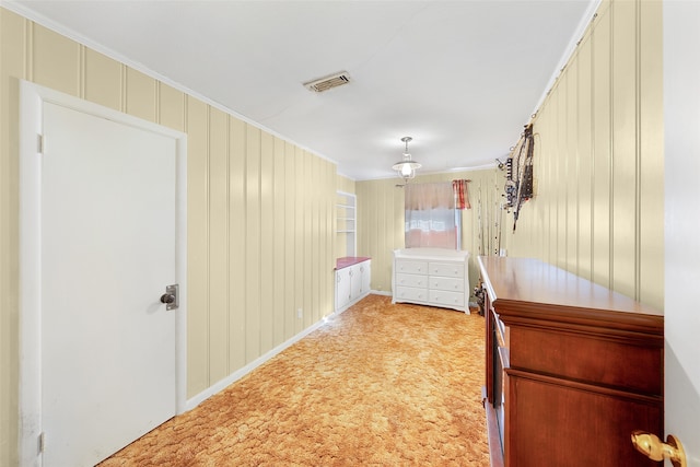 hallway featuring carpet floors and ornamental molding