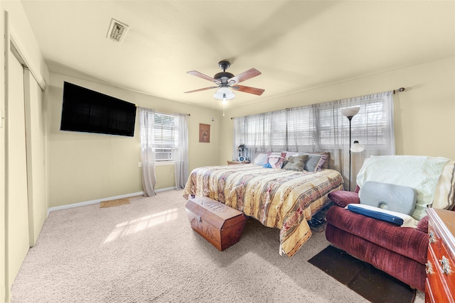 carpeted bedroom featuring a closet, ceiling fan, and cooling unit