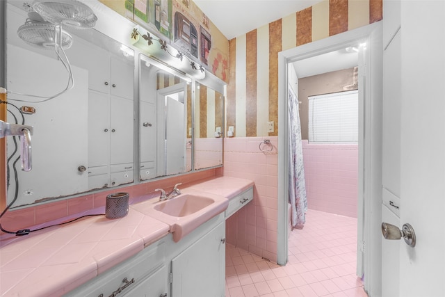 bathroom with tile walls, tile patterned floors, and vanity