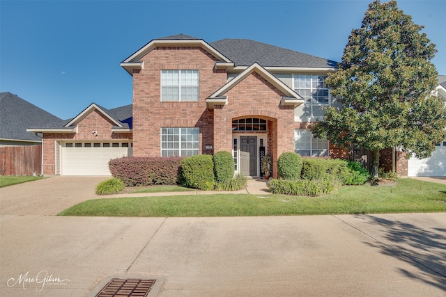 front facade with a garage and a front lawn