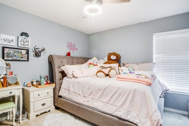 bedroom featuring ceiling fan and light carpet