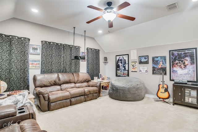 living room featuring lofted ceiling, ceiling fan, and light colored carpet