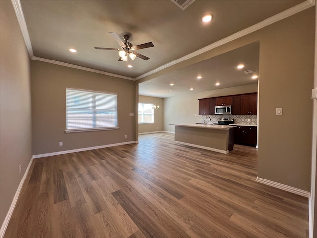 100 Levi Dr, Cleburne, TX 76031 - unfurnished living room featuring ornamental molding, a ceiling fan, a sink, baseboards, and dark wood finished floors