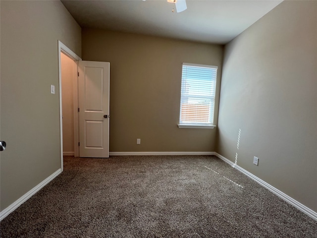 spare room featuring ceiling fan and carpet