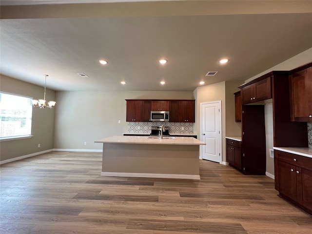 100 Levi Dr, Cleburne, TX 76031 - kitchen featuring stainless steel appliances, a chandelier, a sink, backsplash, and recessed lighting