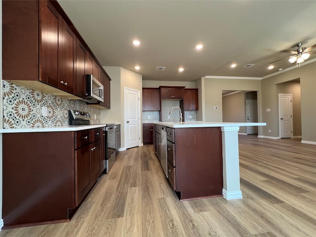100 Levi Dr, Cleburne, TX 76031 - kitchen with stainless steel appliances, light countertops, light wood-type flooring, decorative backsplash, and recessed lighting