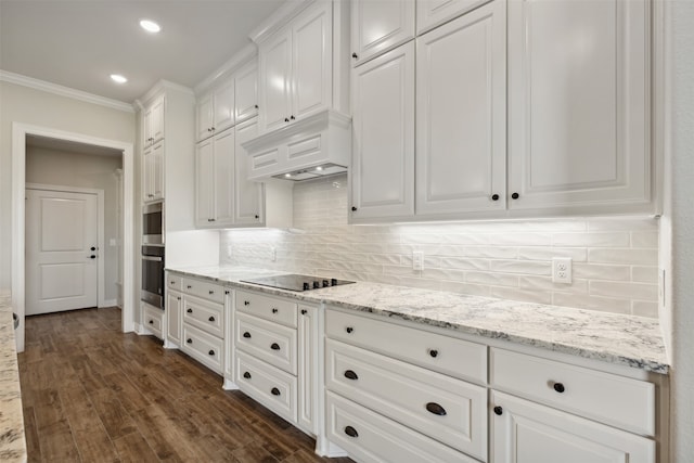 kitchen with black electric stovetop, light stone counters, white cabinetry, dark hardwood / wood-style flooring, and ornamental molding