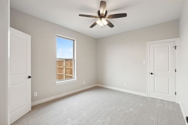 empty room with ceiling fan and light colored carpet