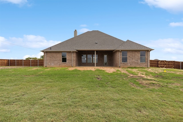 back of house featuring a yard