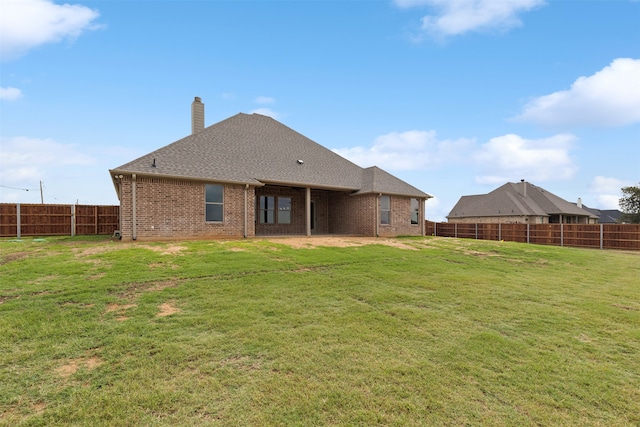 back of house featuring a yard and a patio area