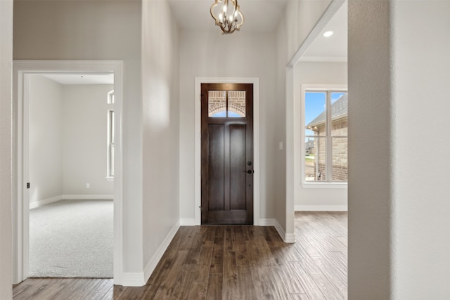 foyer featuring a notable chandelier and dark hardwood / wood-style flooring