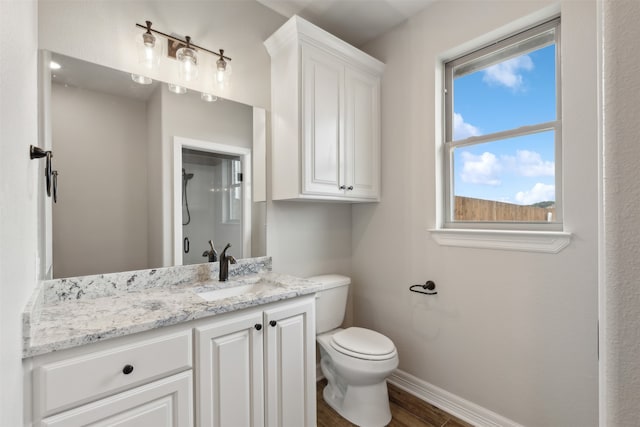 bathroom featuring wood-type flooring, vanity, and toilet