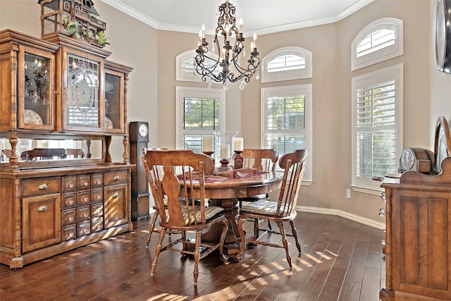 dining area with crown molding, a high ceiling, dark wood-type flooring, and a chandelier