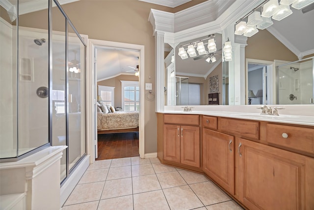 bathroom with crown molding, tile patterned floors, a shower with shower door, ceiling fan, and vanity