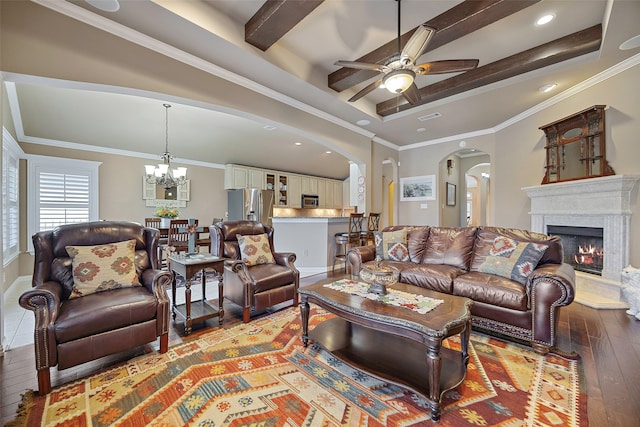 living room with light hardwood / wood-style flooring, beamed ceiling, ceiling fan with notable chandelier, and ornamental molding