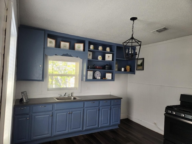 kitchen with blue cabinets, a textured ceiling, black range with gas cooktop, dark hardwood / wood-style floors, and sink