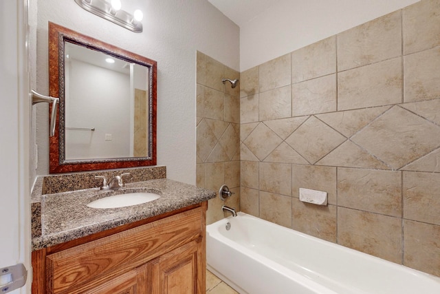 bathroom featuring vanity and tiled shower / bath combo