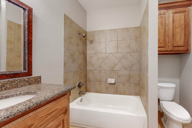 full bathroom featuring vanity, tiled shower / bath combo, and toilet