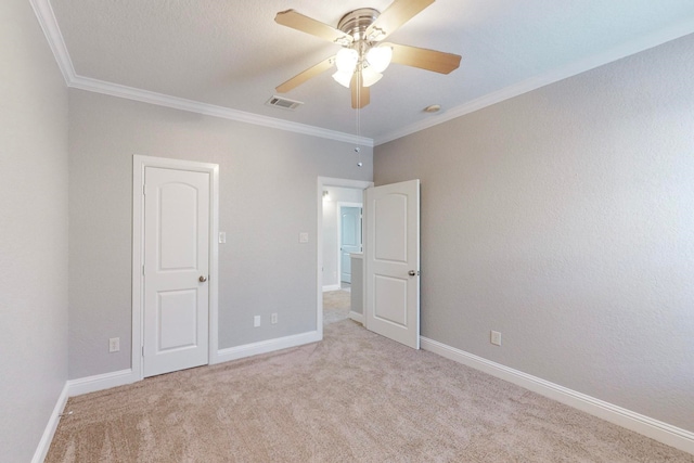 interior space featuring crown molding, light carpet, and ceiling fan