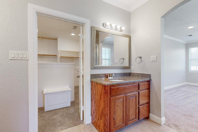 bathroom featuring vanity, tile patterned flooring, and ornamental molding