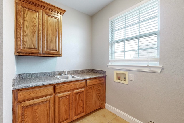 kitchen featuring light tile patterned flooring and sink