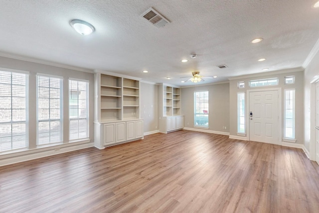 entryway with ceiling fan, a textured ceiling, light hardwood / wood-style flooring, and crown molding