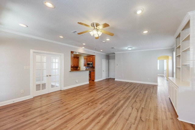 unfurnished living room with ceiling fan, light wood-type flooring, and crown molding