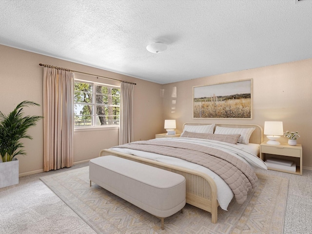 bedroom with a textured ceiling and light carpet