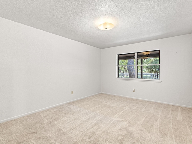 carpeted spare room featuring a textured ceiling