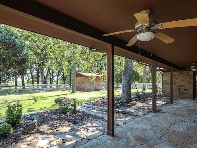 view of patio / terrace featuring ceiling fan and a shed