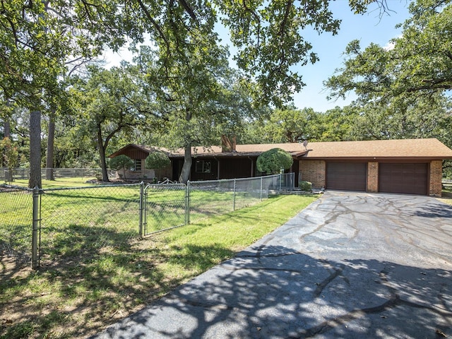 ranch-style house with a garage and a front lawn