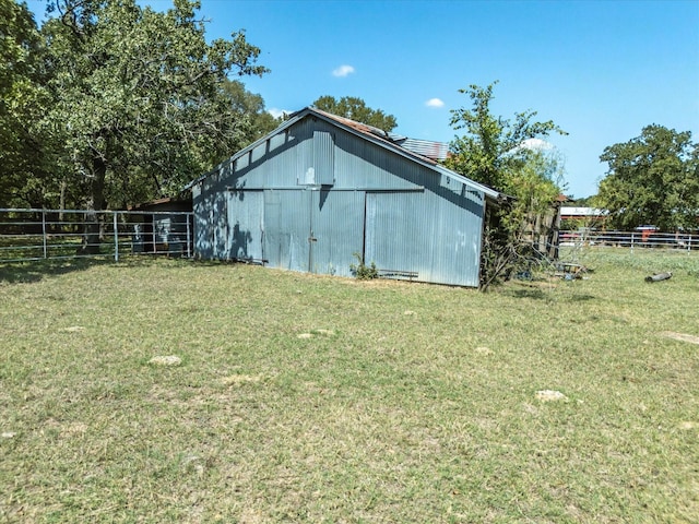 view of outbuilding featuring a yard