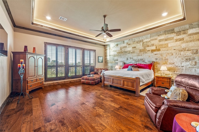 bedroom featuring a tray ceiling, ceiling fan, and dark hardwood / wood-style flooring