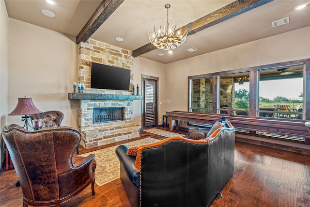 living room with a fireplace, hardwood / wood-style floors, beamed ceiling, and a wealth of natural light