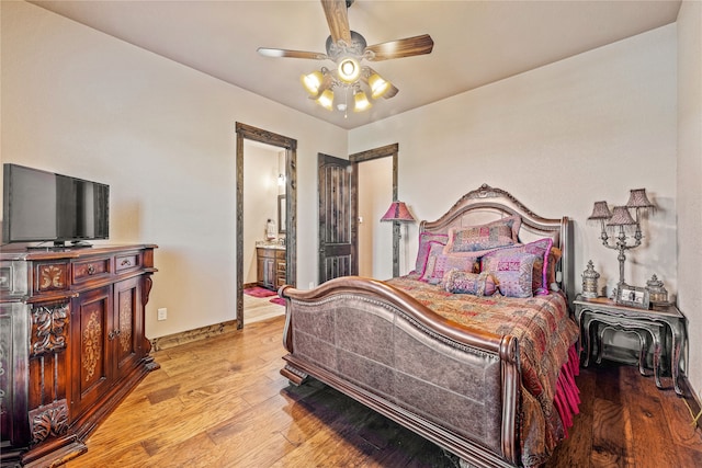 bedroom with ceiling fan, light hardwood / wood-style flooring, and ensuite bath