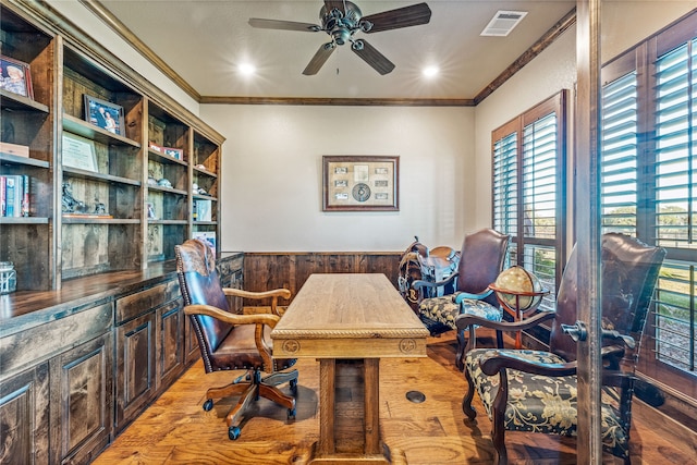 office with ornamental molding, wood walls, ceiling fan, and light hardwood / wood-style floors