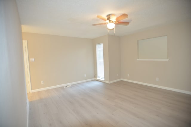 spare room with light hardwood / wood-style floors, ceiling fan, and a textured ceiling