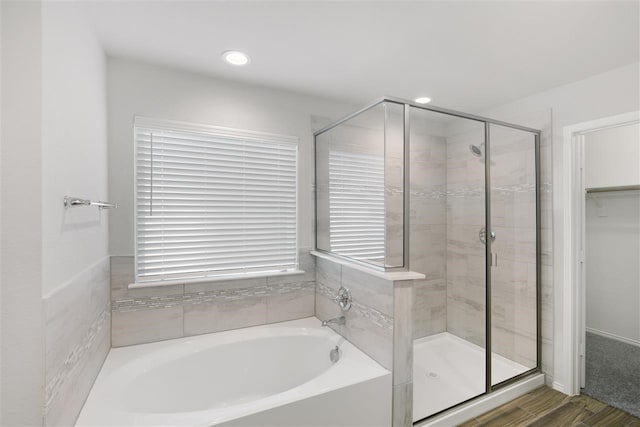 bathroom with hardwood / wood-style floors and plus walk in shower