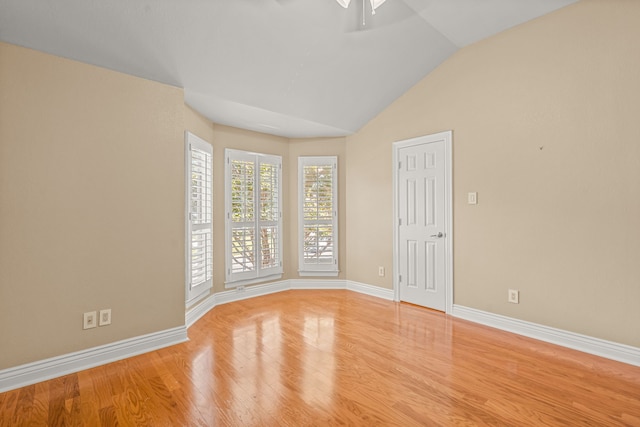 unfurnished bedroom with ceiling fan, light wood-type flooring, and lofted ceiling