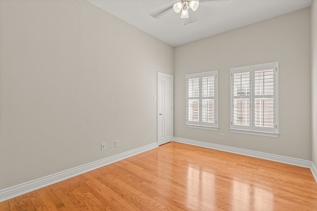 spare room with light wood-type flooring and ceiling fan