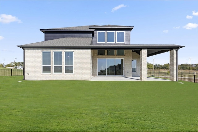 rear view of house with a yard and a patio area