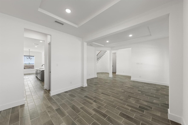 unfurnished room with a raised ceiling