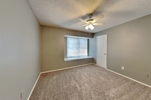 spare room with ceiling fan, a textured ceiling, and carpet floors