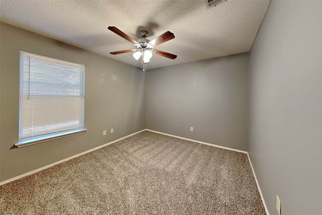 carpeted empty room with a textured ceiling and ceiling fan